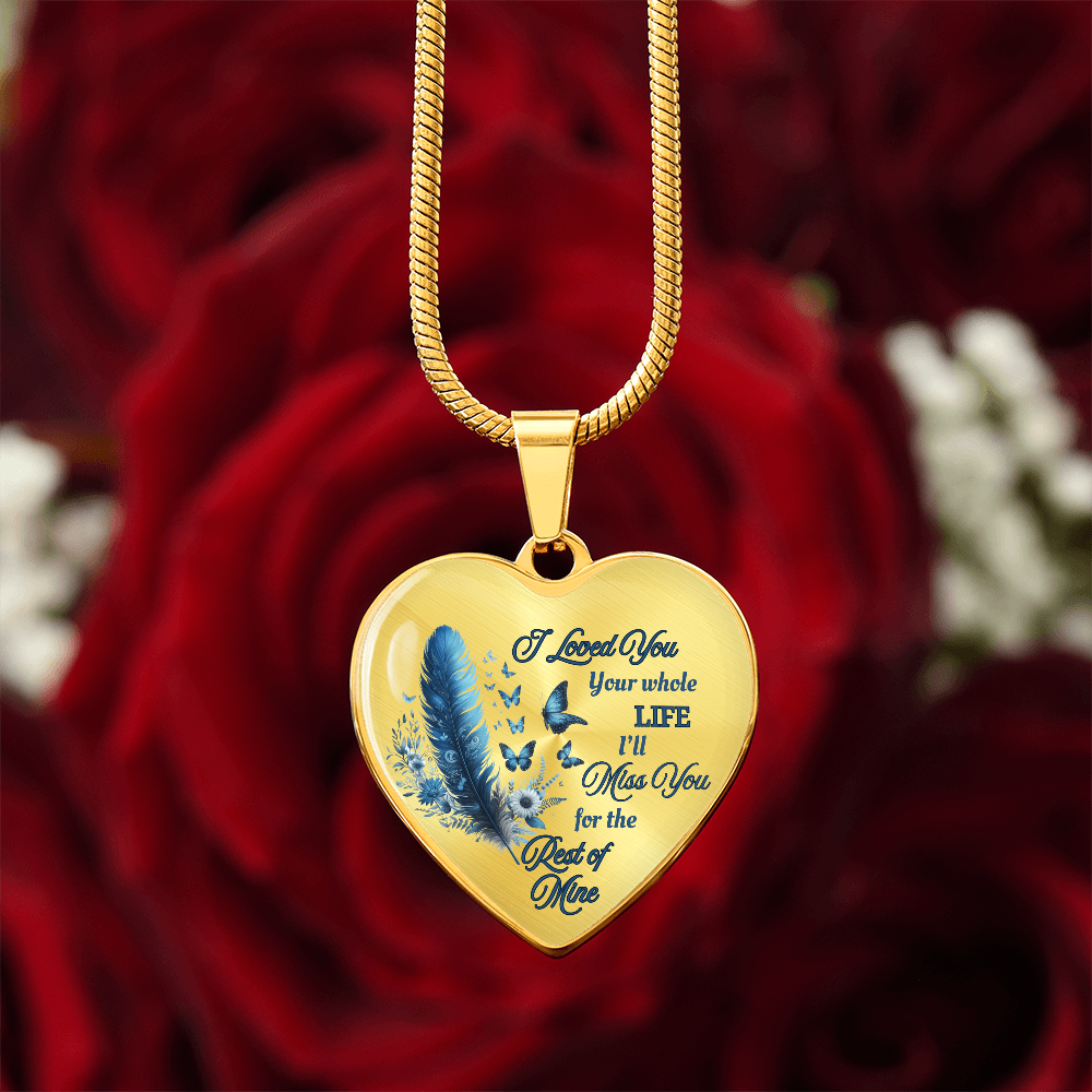 Gold heart-shaped pendant necklace with blue feather and engraved sentimental message.