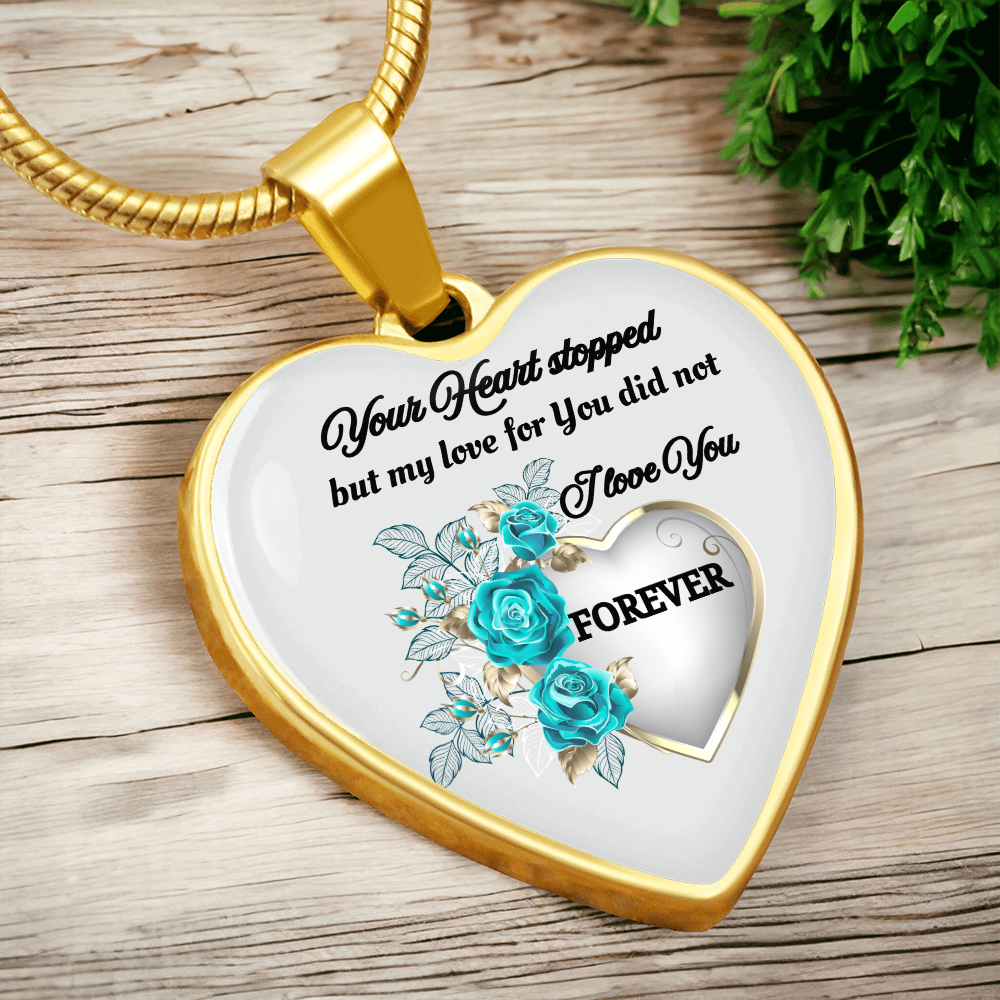Gold heart-shaped pendant necklace with blue roses and engraved memorial message.