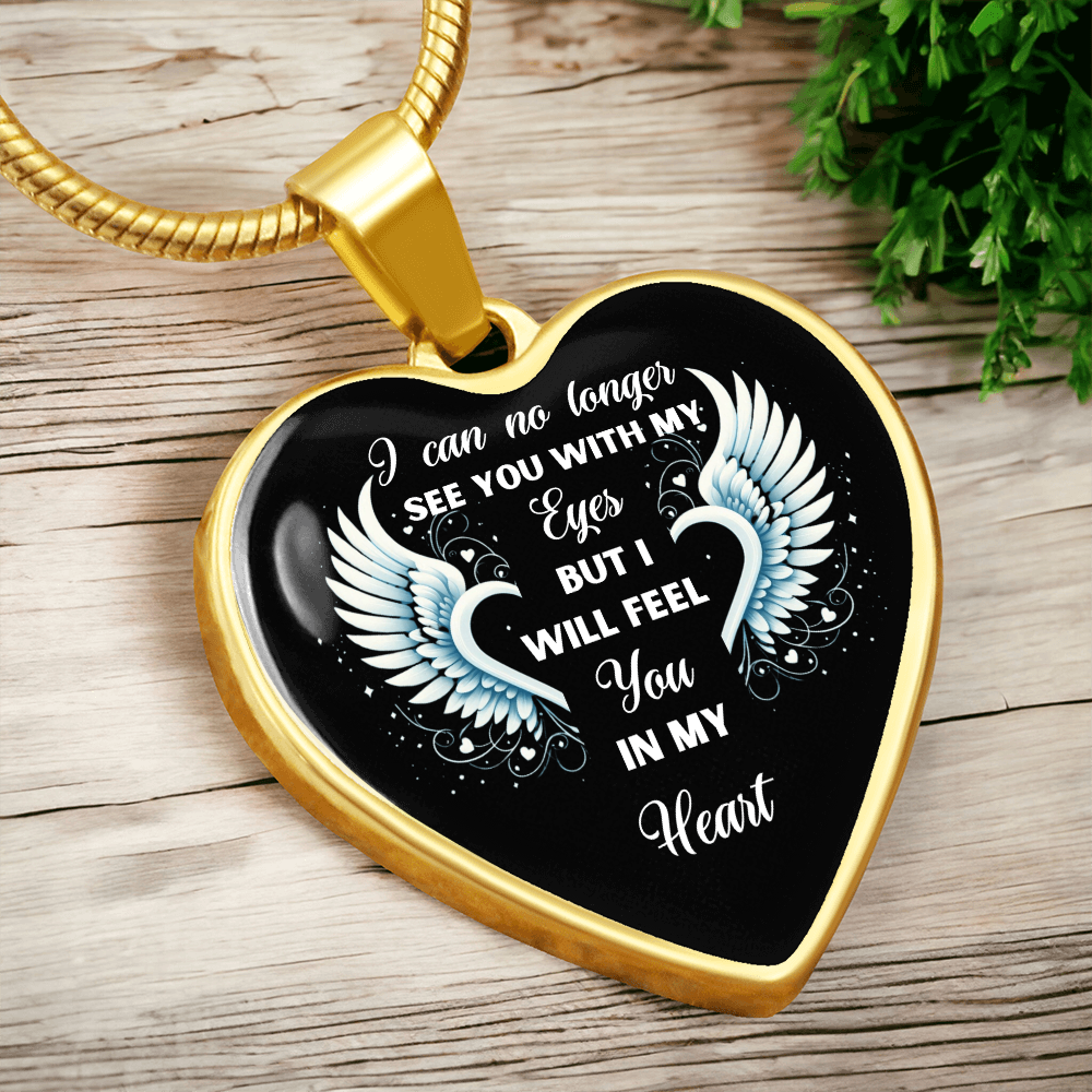 Gold heart-shaped pendant necklace with angel wings and text.