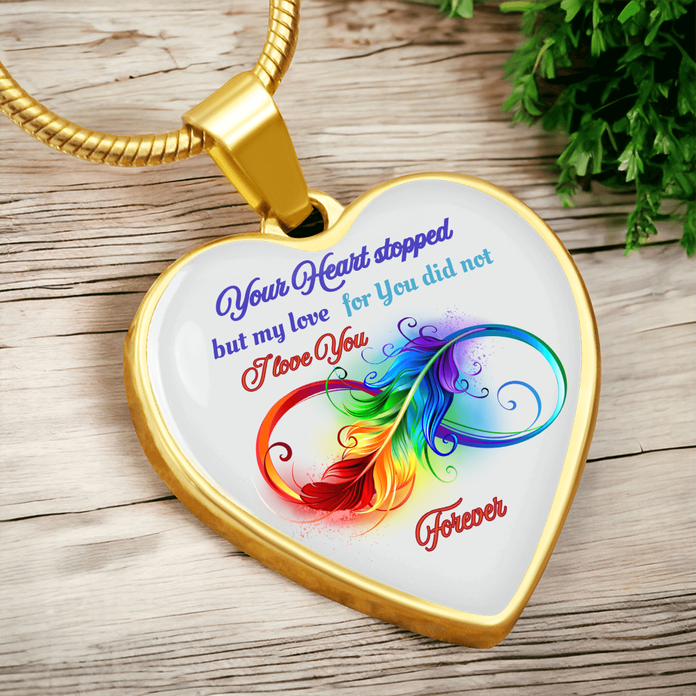 Gold heart pendant necklace with colorful feather and "Your Heart Stopped but My Love for You Did Not" text.
