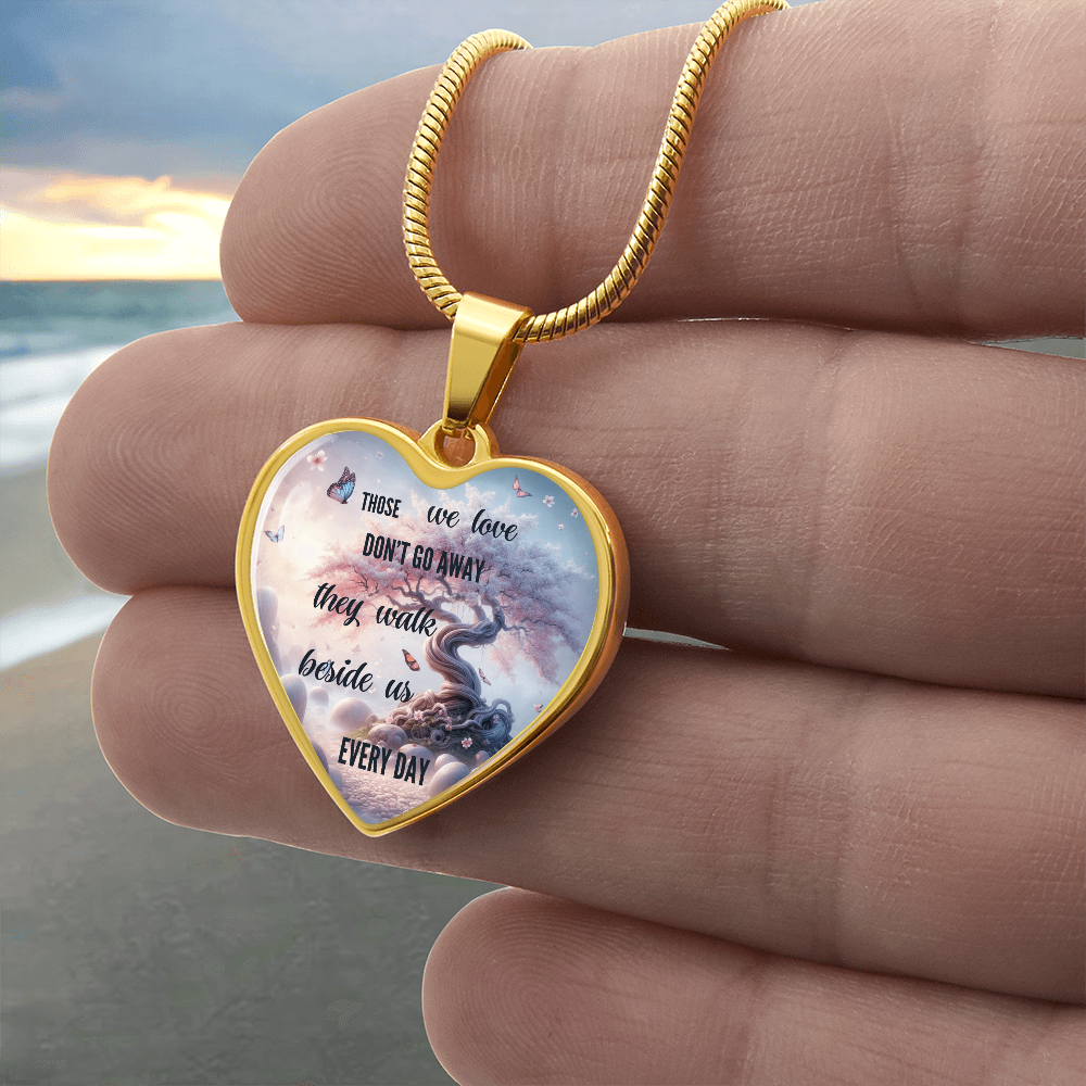 Gold heart-shaped pendant necklace with engraved sentimental message and sky background design.
