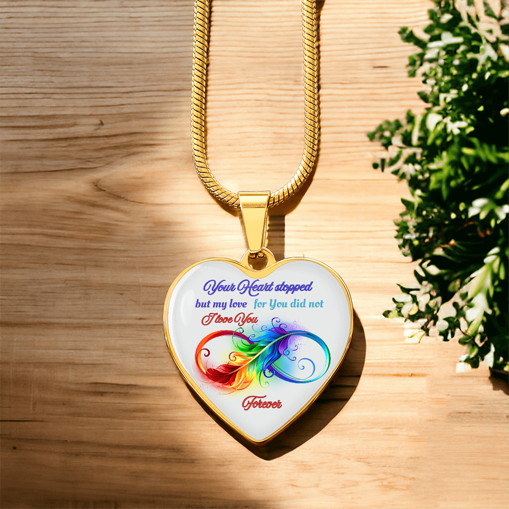 Gold heart-shaped pendant necklace with colorful intertwined heart design and engraved sentimental message.