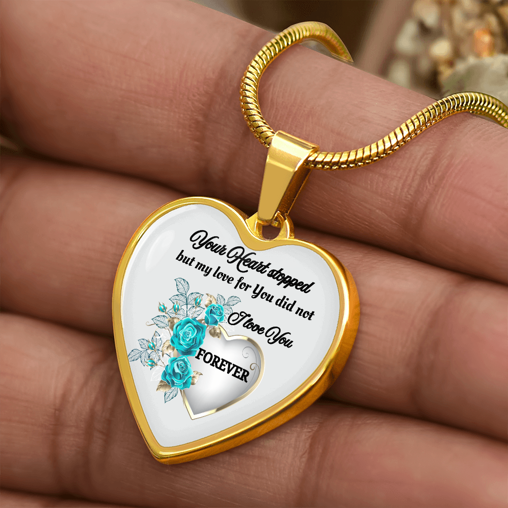 Gold heart-shaped pendant necklace with blue roses and engraved sentimental message.