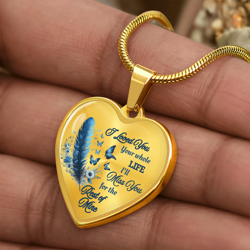 Gold heart-shaped pendant necklace with blue feather design and engraved sentimental message.