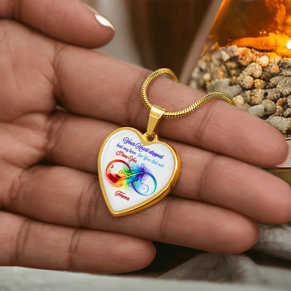 Heart-shaped gold pendant necklace with colorful bicycle and sentimental memorial text on white background.