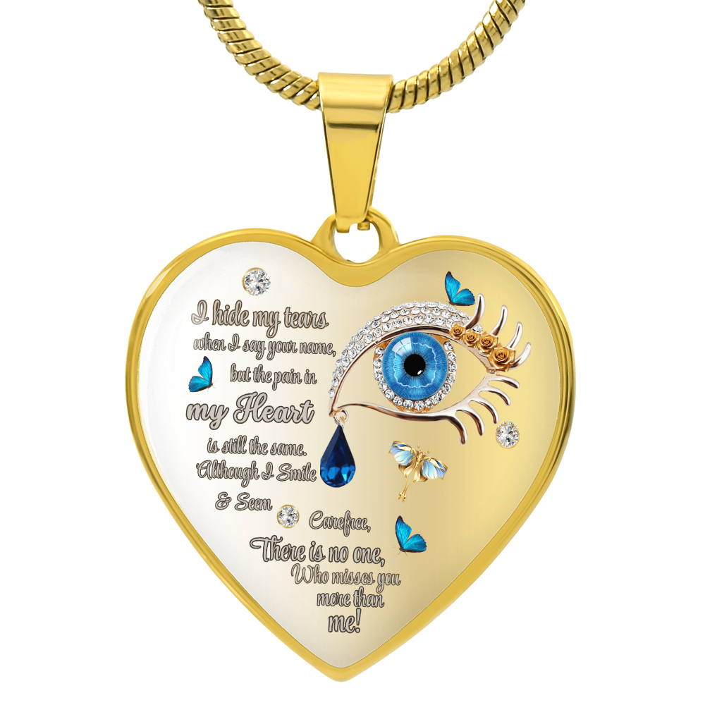 Gold heart-shaped necklace pendant with blue eye, tear drops, and engraved poetic text.