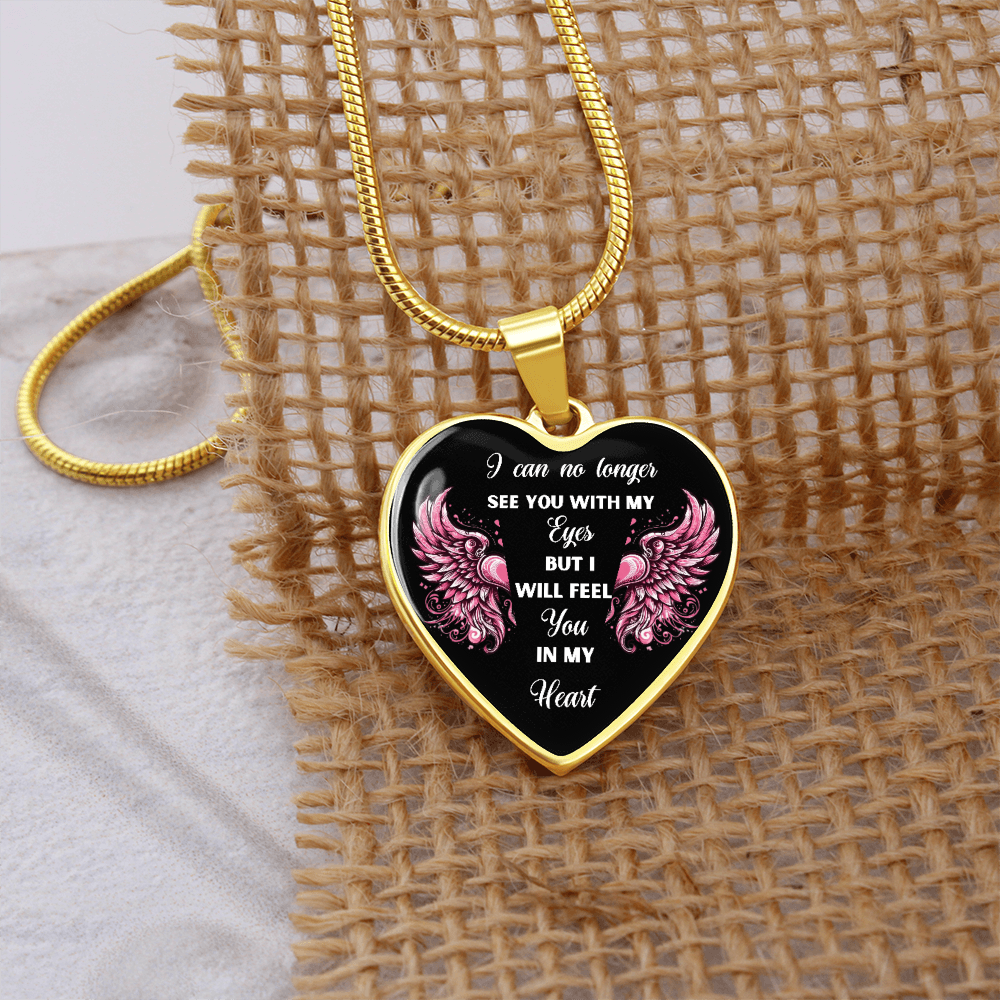 Gold heart-shaped pendant necklace with black center and pink angel wings, sentimental quote engraving.
