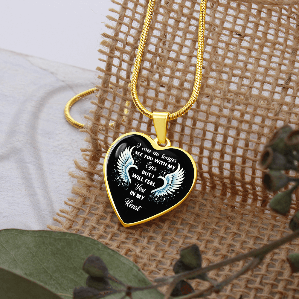 Gold heart-shaped pendant necklace with angel wings and "I can no longer see you with my eyes but I will feel you in my heart" inscription.

