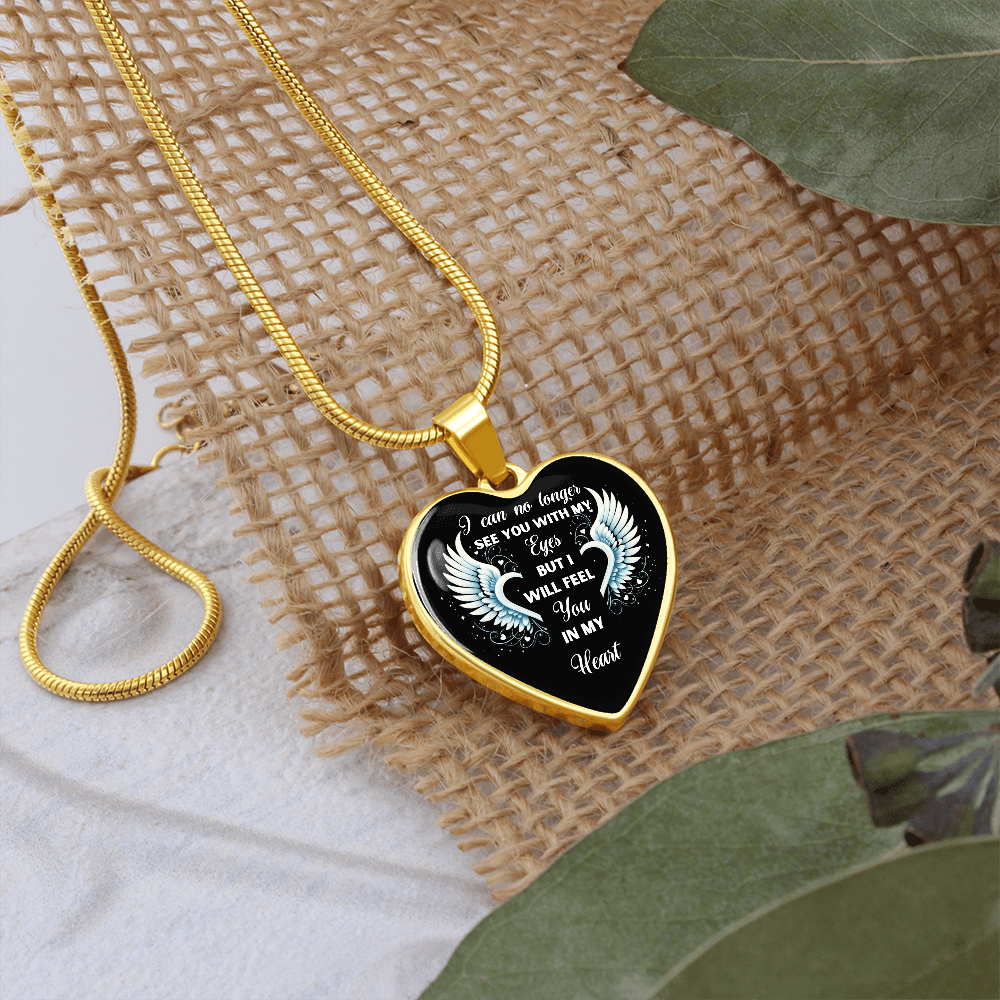 Heart-shaped pendant necklace with gold chain.