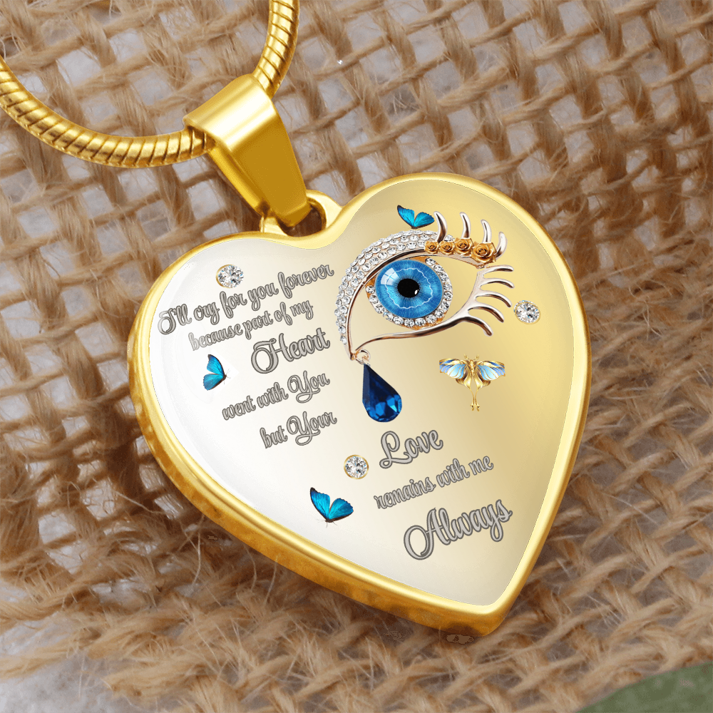 Gold heart-shaped pendant necklace with an eye design, a blue teardrop, butterflies, and the phrases "I'll cry for you forever because part of my heart went with you but your love remains with me always".