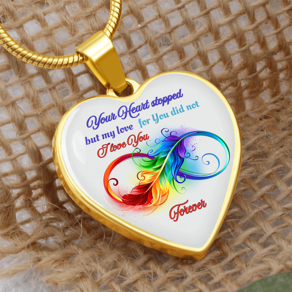Gold heart pendant necklace with colorful feather design and sentimental blue and red text.