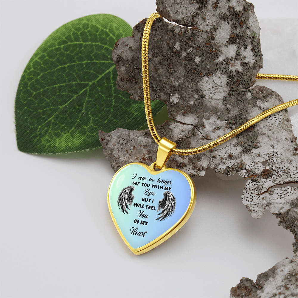 Heart-shaped gold necklace with angel wings design and memorial message.
