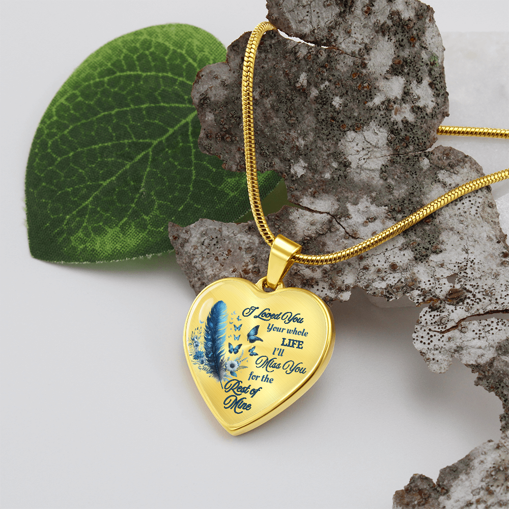 Gold heart-shaped pendant necklace with blue feather design and engraved letter detail.
