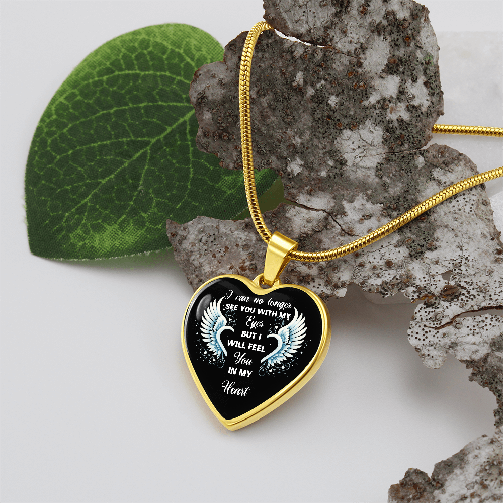 Gold heart-shaped pendant necklace with black center and engraved sympathy message on gold chain.