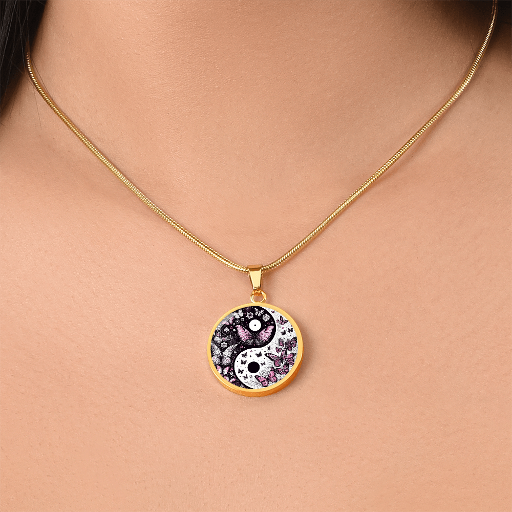Gold circular pendant necklace featuring a yin yang design with violet butterflies on a black and white background.