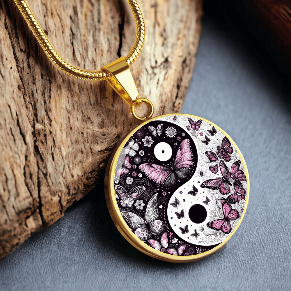 Gold circular pendant necklace featuring a yin yang symbol with violet butterflies and floral details.