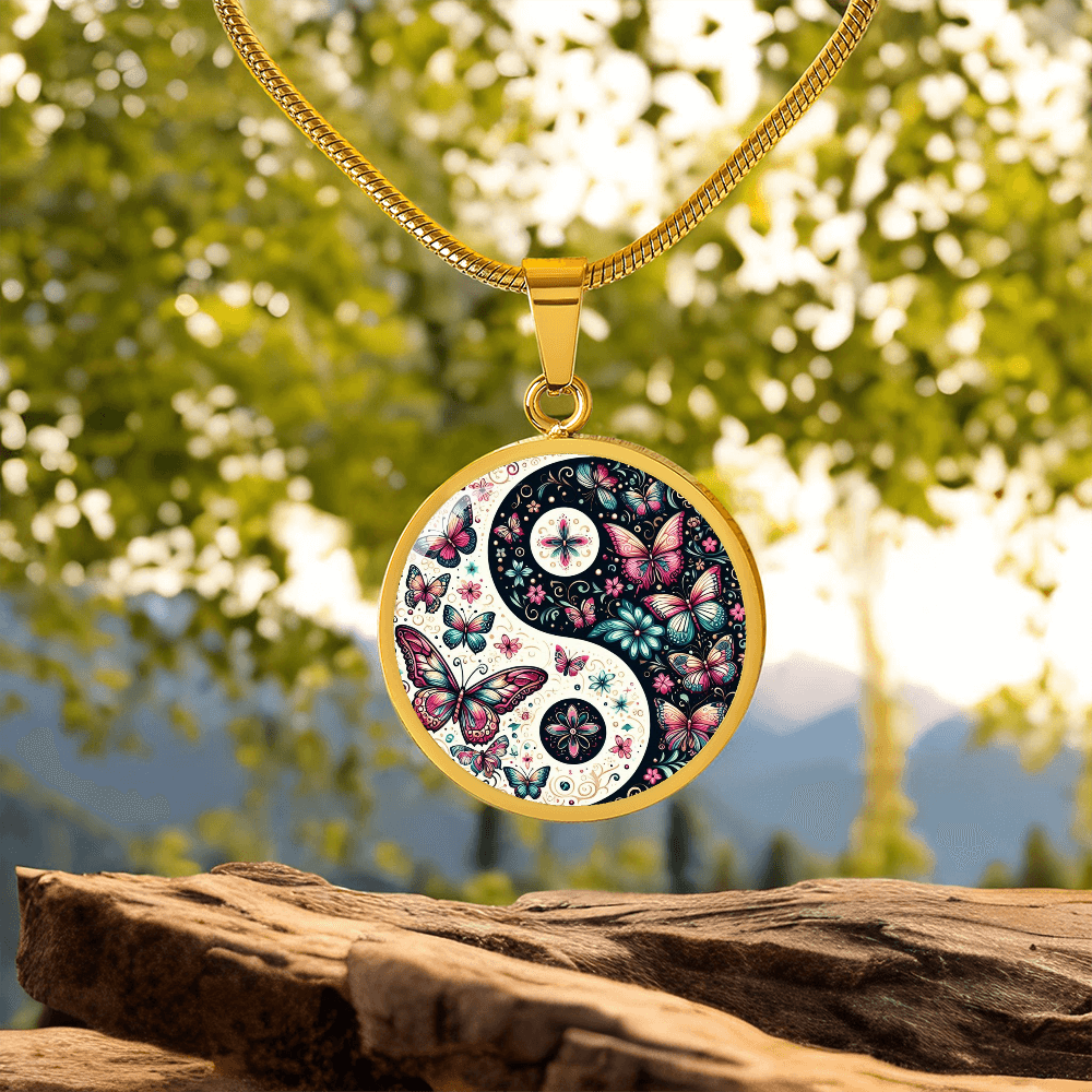Gold circle pendant necklace with pink butterfly yin yang design on gold chain.