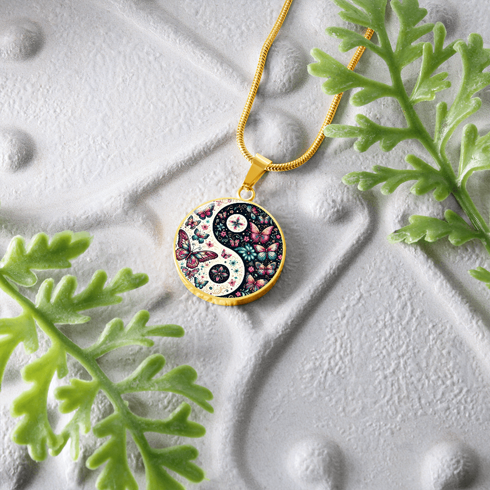 Gold Yin Yang pendant with pink butterfly and floral design on gold chain necklace.