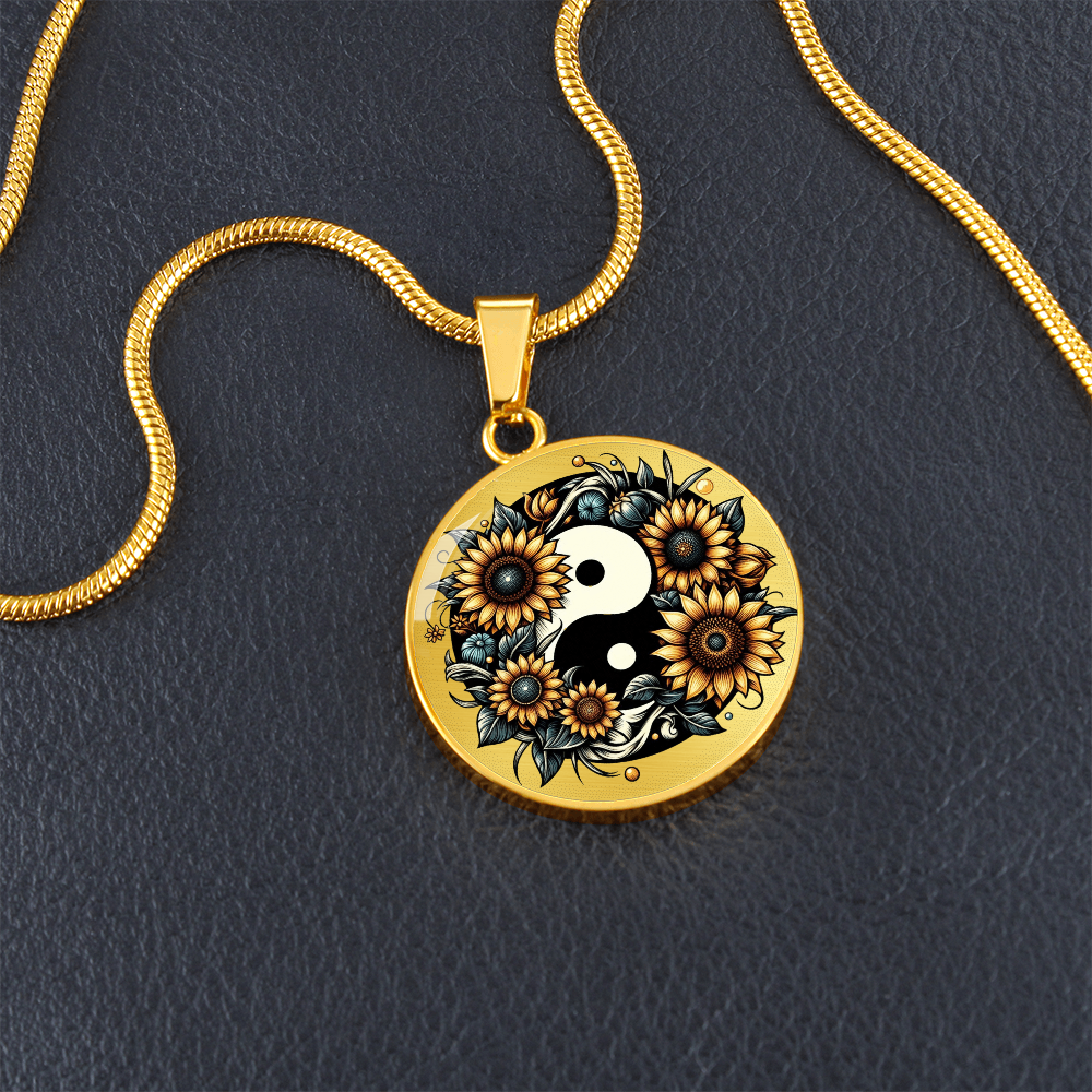 Gold circular pendant necklace with yin yang symbol surrounded by sunflowers and black floral details.