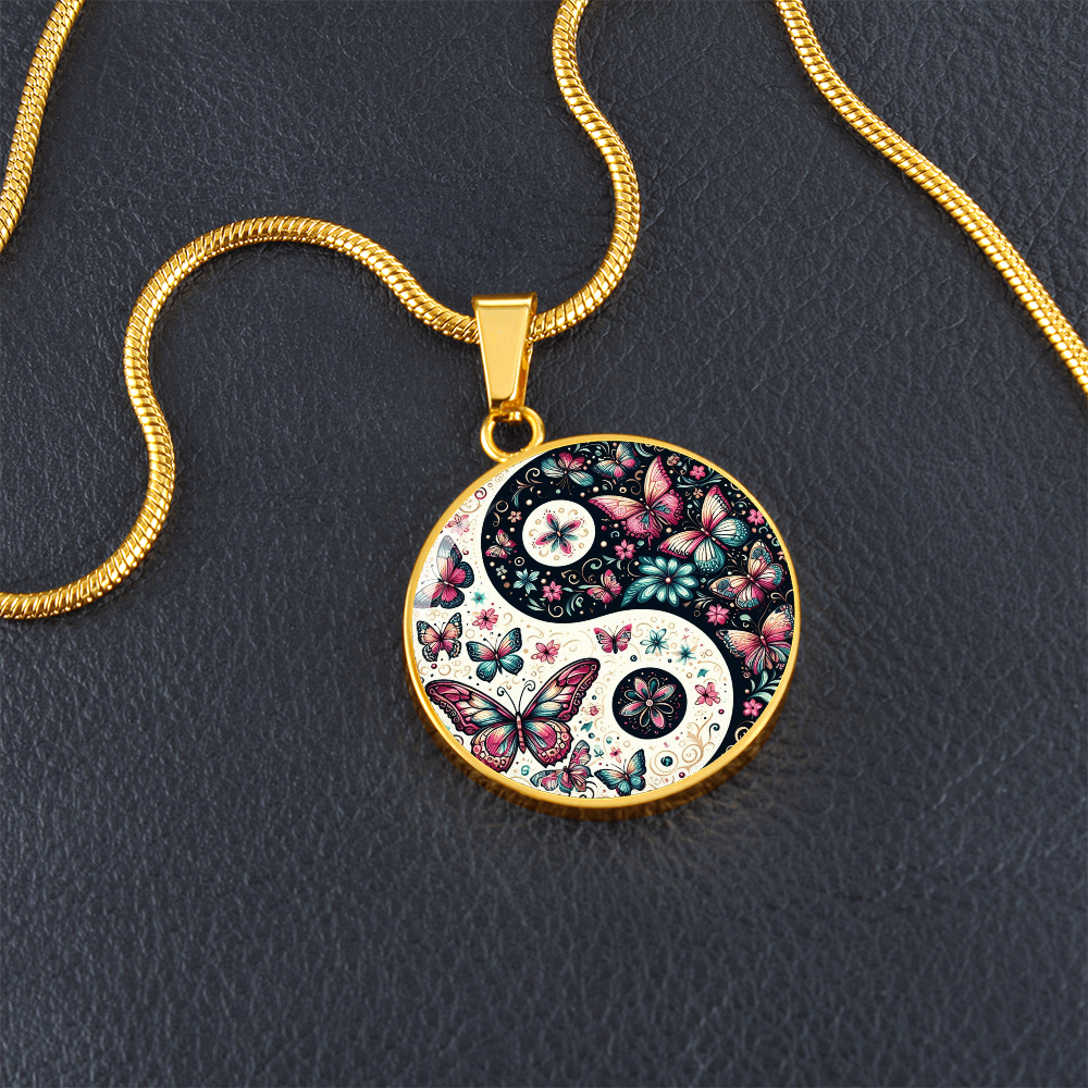 Gold chain necklace with a butterfly and floral yin yang pendant.