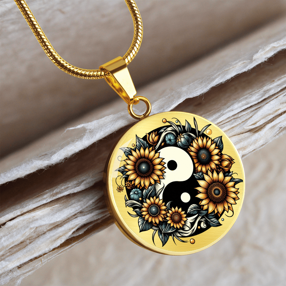 Gold round necklace pendant featuring a yin yang symbol surrounded by vibrant sunflowers and leaves.