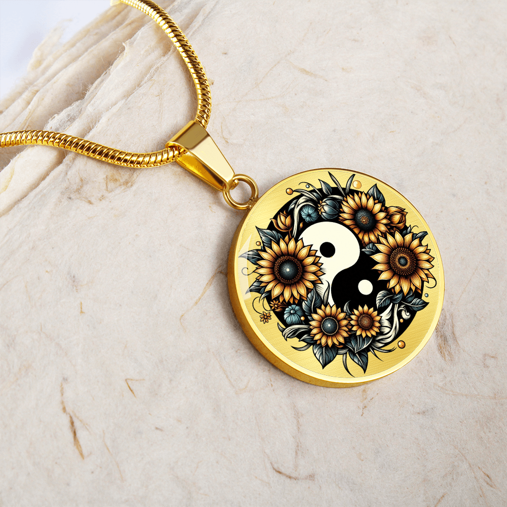 Gold circular pendant necklace featuring a yin yang symbol with detailed sunflower and leafy design.