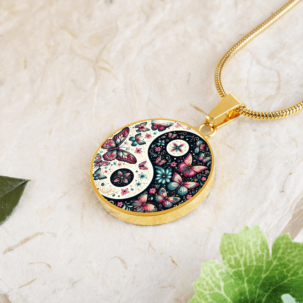 Gold circle necklace pendant featuring a pink butterfly yin yang design with floral accents.