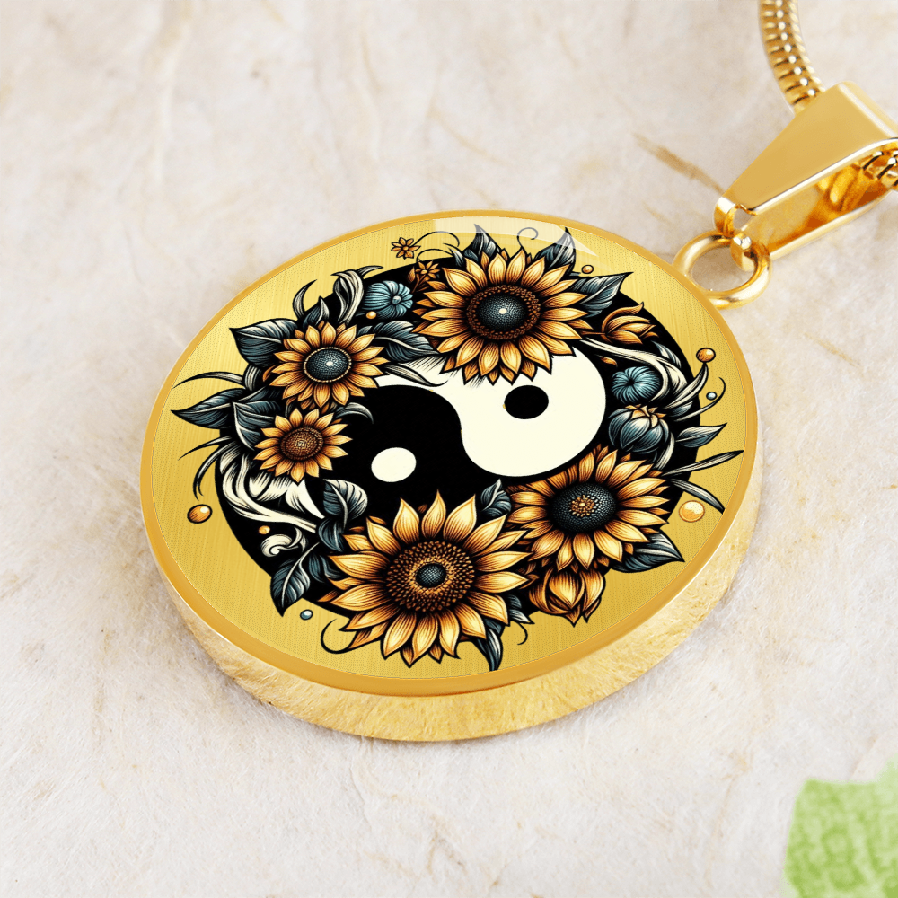 Gold circular necklace pendant featuring a yin yang symbol surrounded by detailed sunflower design.