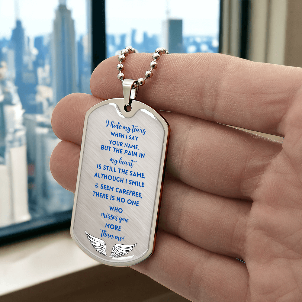Silver memorial military tag necklace with blue engraved script and angel wings design.