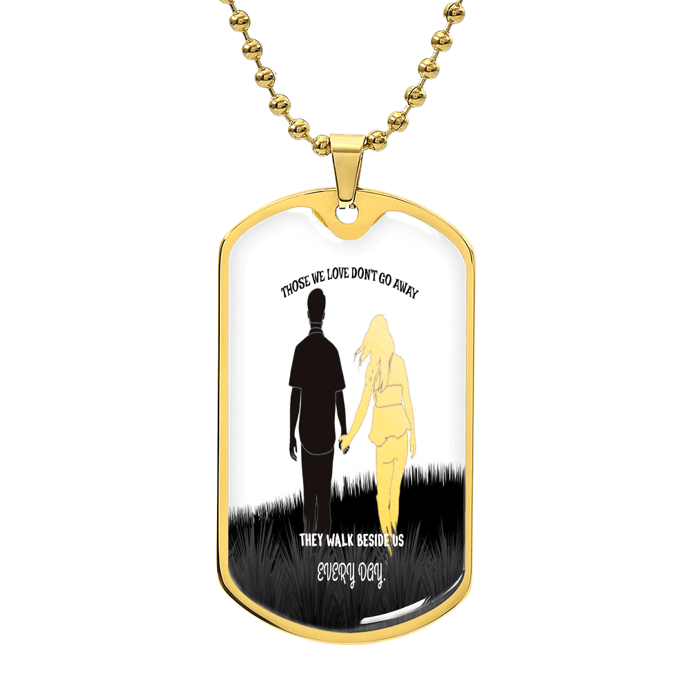 Gold dog tag necklace with silhouette of couple holding hands and engraved remembrance text.