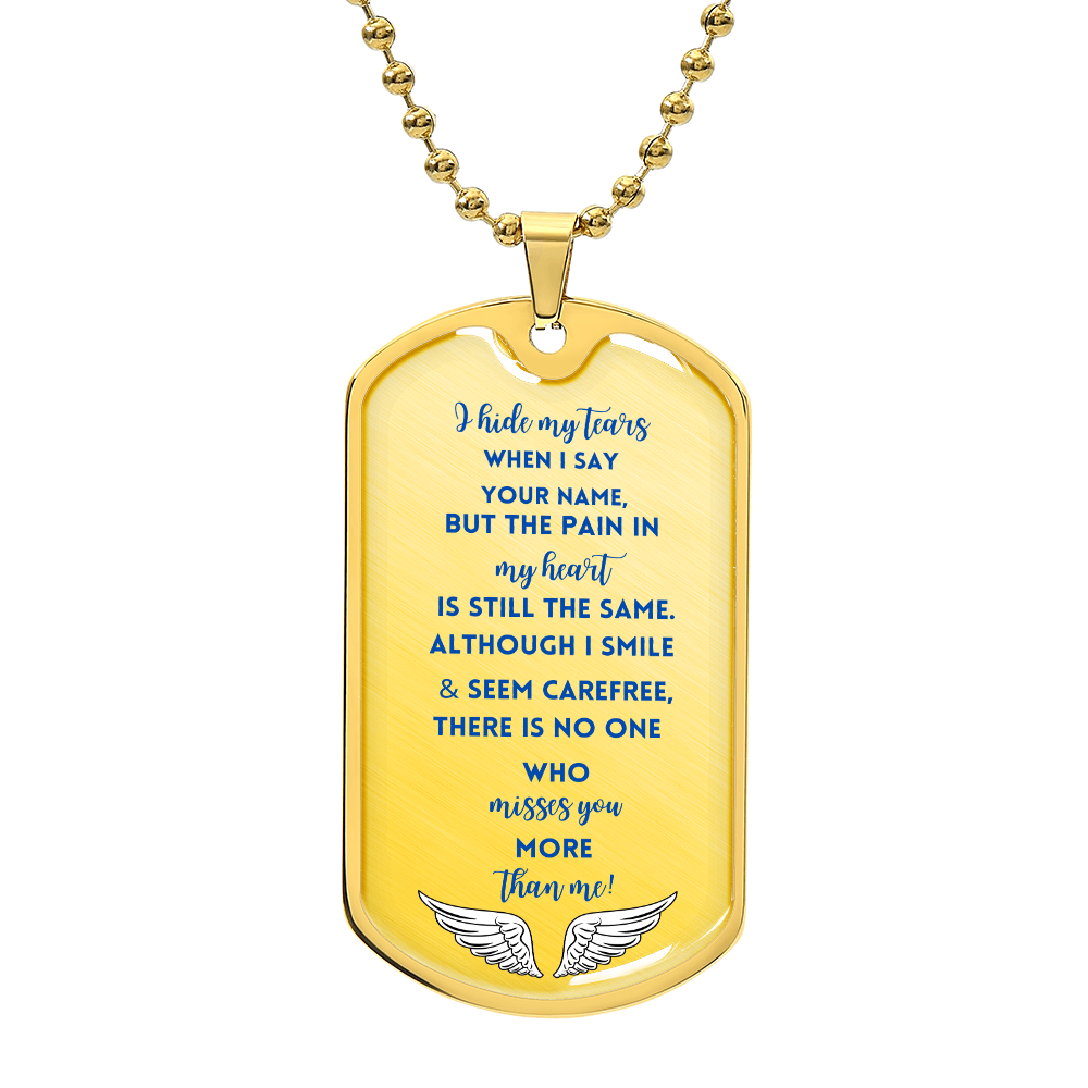 Gold military dog tag necklace with blue sentimental text and white angel wings design at bottom.