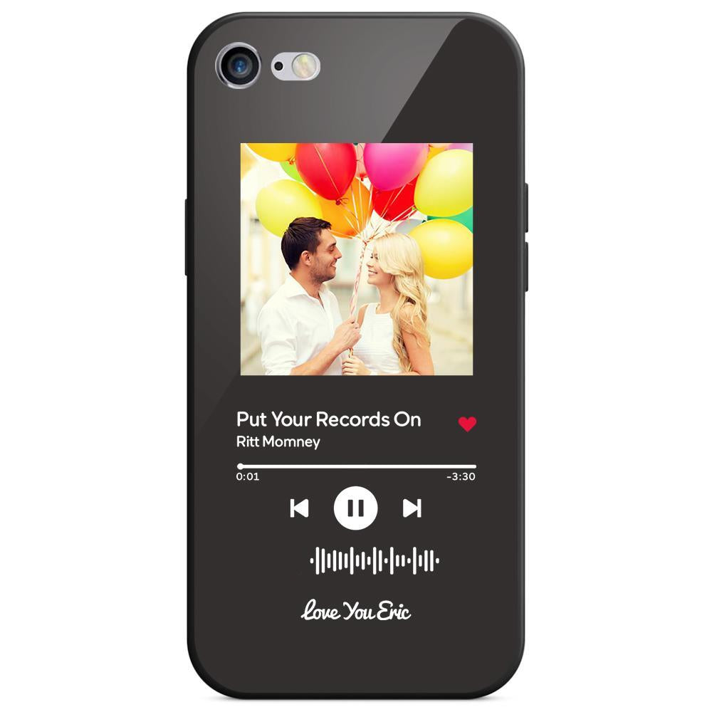 Black phone case with a photo of a couple holding balloons, with music player interface over the image.