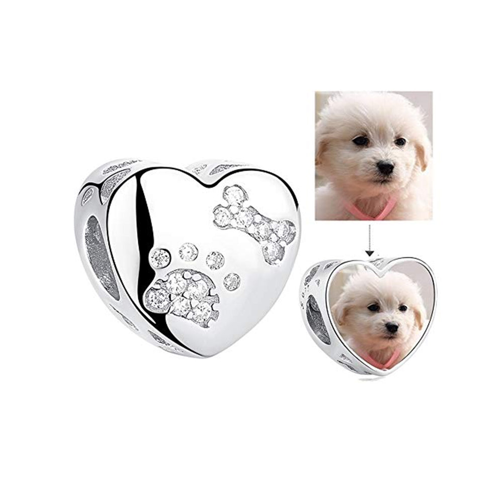 Silver heart charm with engraved paw print and bone, customizable with pet photo insert.