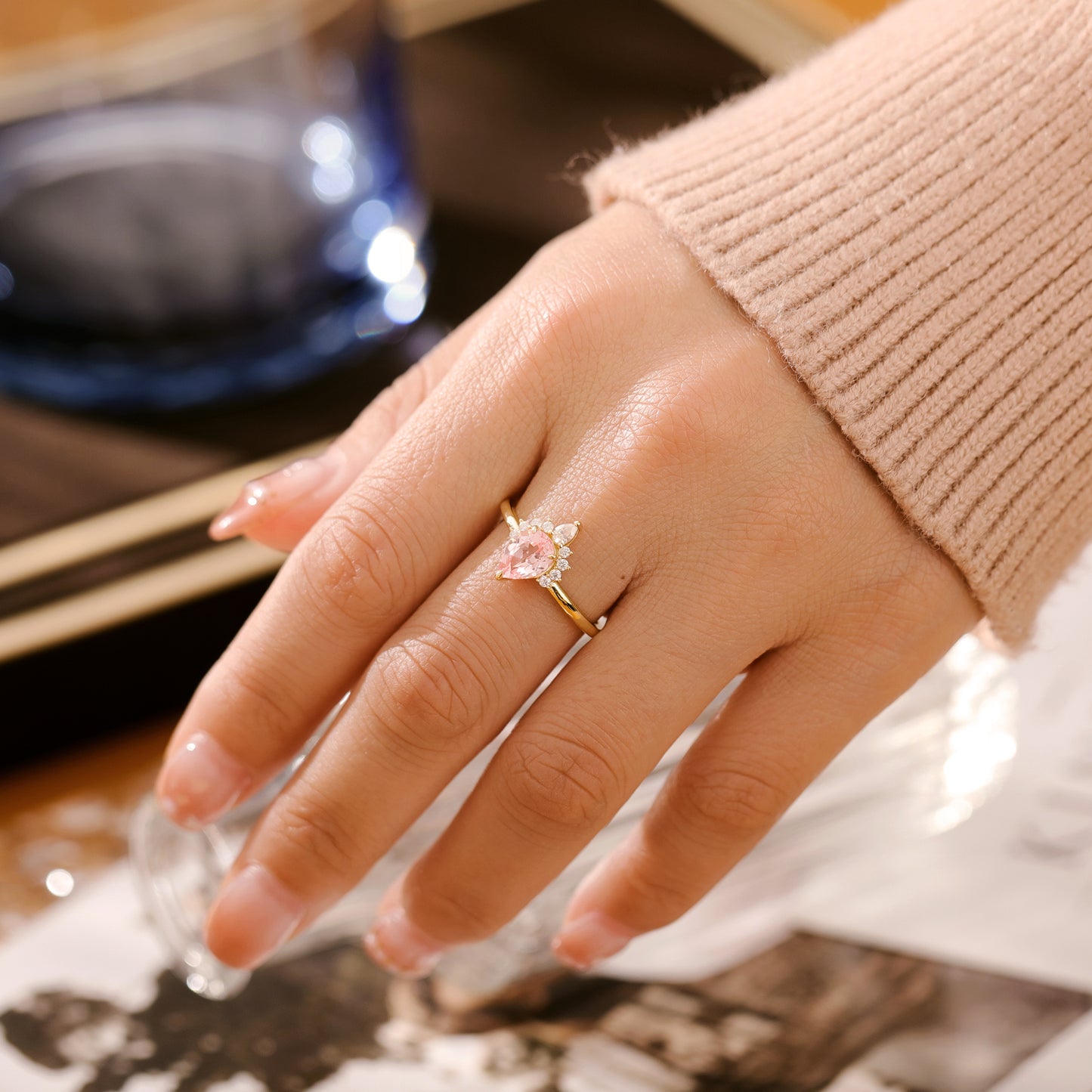925 Sterling Silver Lab Pink Sapphire Ring with pear-shaped pink sapphire and gold plated band on hand