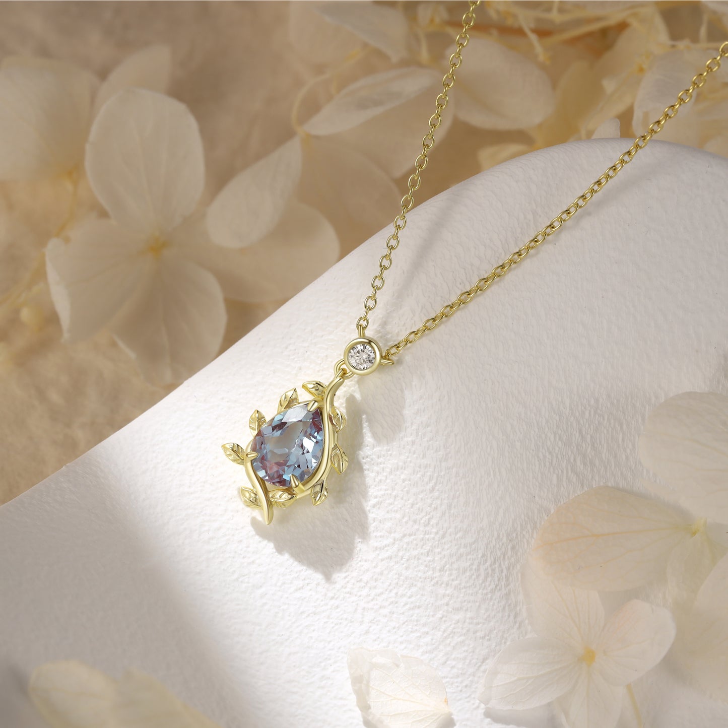 925 Sterling Silver Lab Alexandrite Necklace with pear-shaped purple gemstone and gold color band displayed on white textured surface