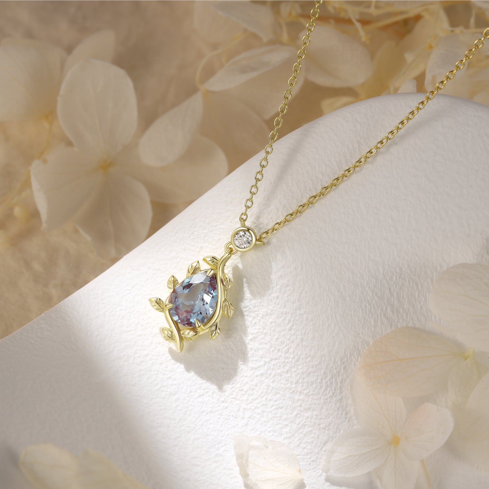 925 Sterling Silver Lab Alexandrite Necklace with pear-shaped purple gemstone and gold color band displayed on white textured surface