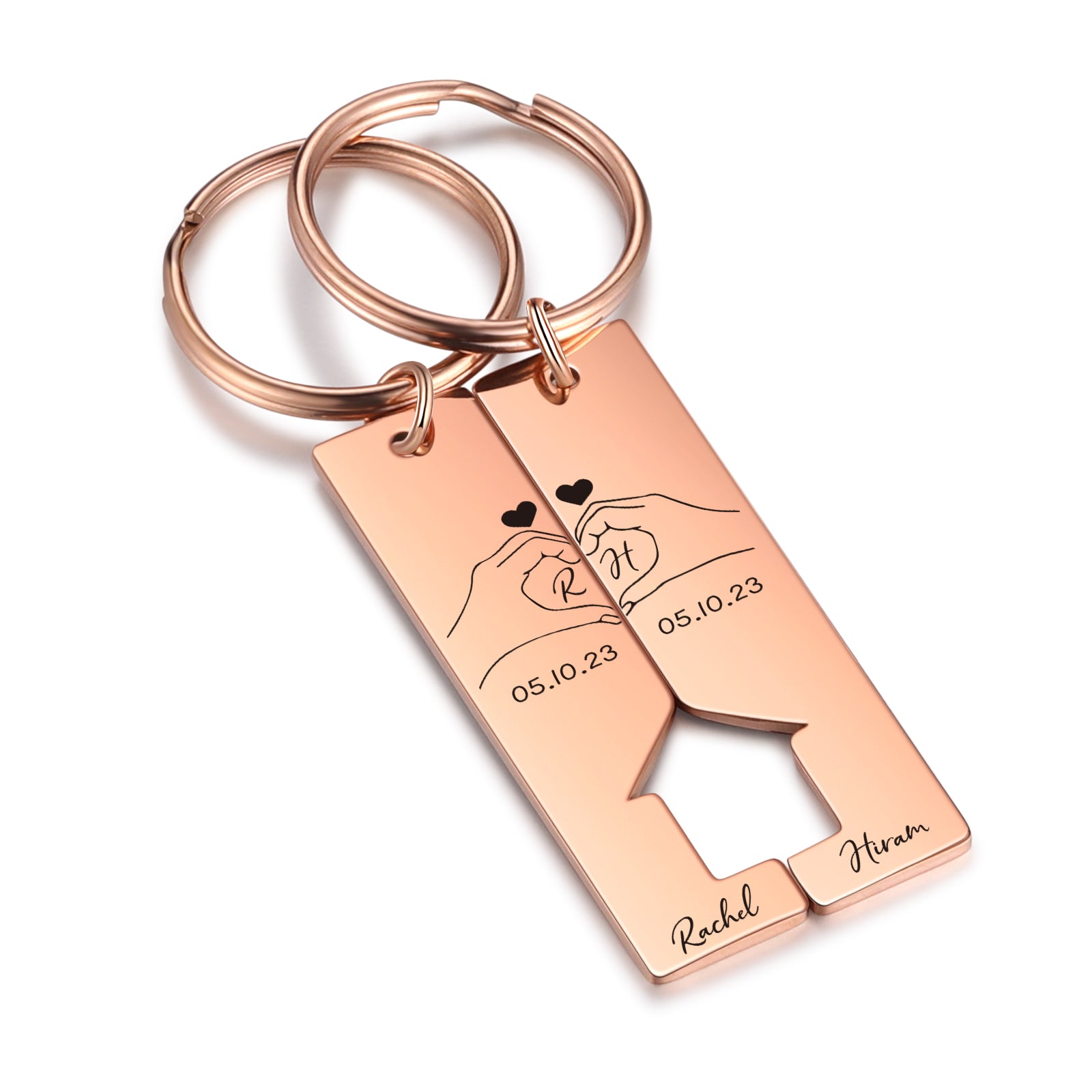 Rose gold stainless steel rectangular keychain with a cut-out heart in the center, engraved initials, and a couple hand.