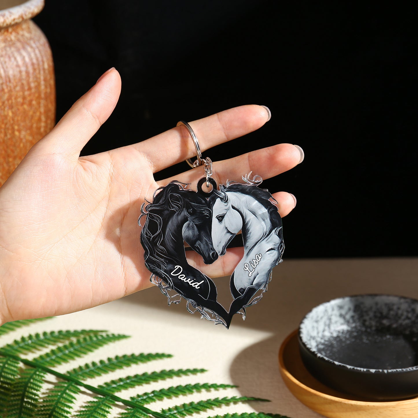 Black acrylic heart-shaped keychain featuring two intertwined horses, one black and one white, with the name "David" in.