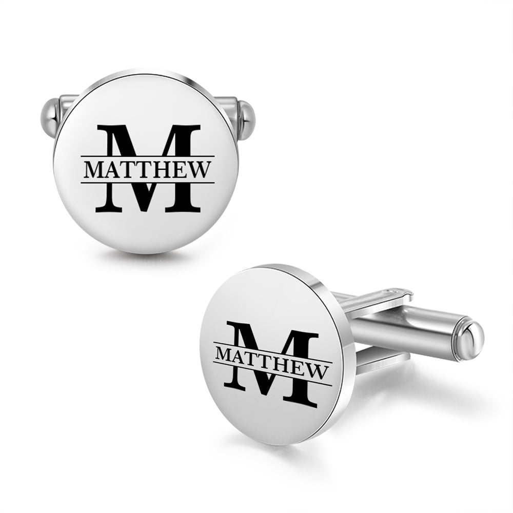 Round stainless steel cufflinks with bold black letter M and personalized name Matthew in modern font.