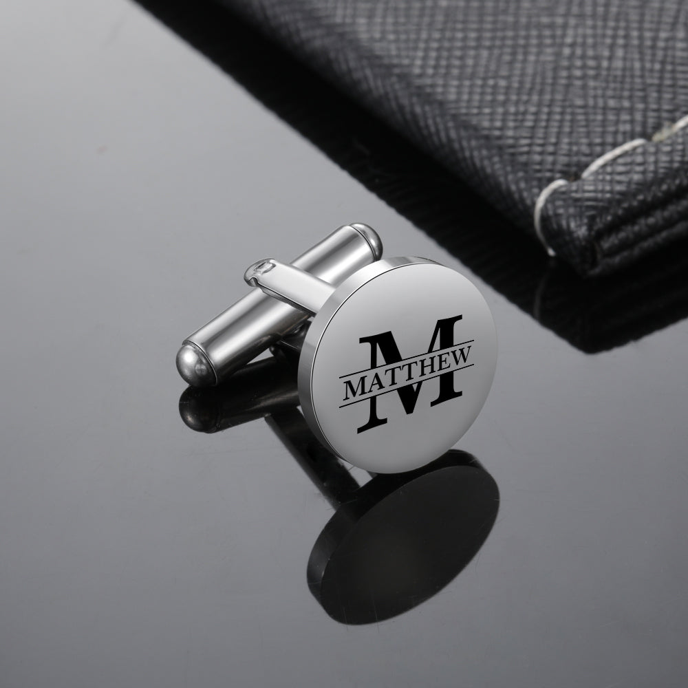 Round silver stainless steel cufflink with black engraved initial "M" and name "Matthew" in the center.