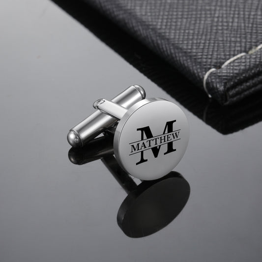Round silver stainless steel cufflink with black engraved initial "M" and name "Matthew" in the center.