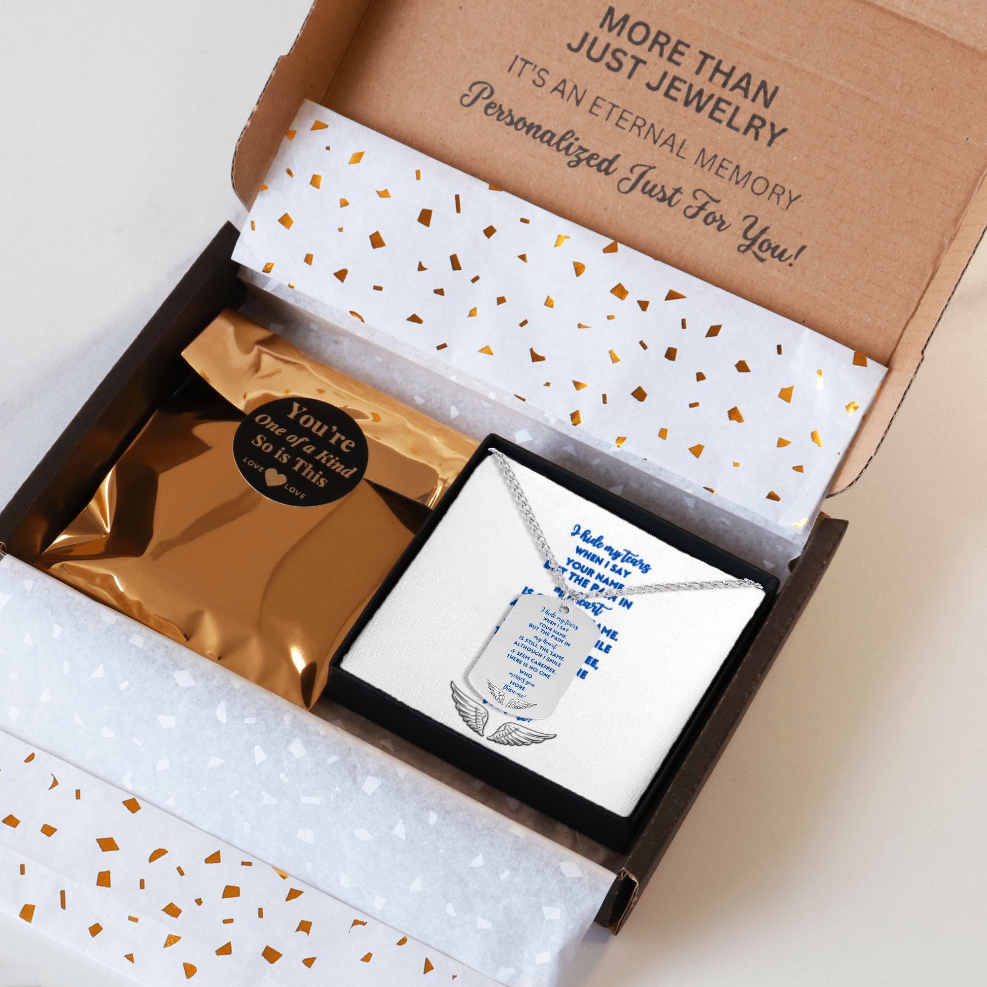 Memorial tag necklace with engraved message in black and silver display box, sympathy gift packaging.