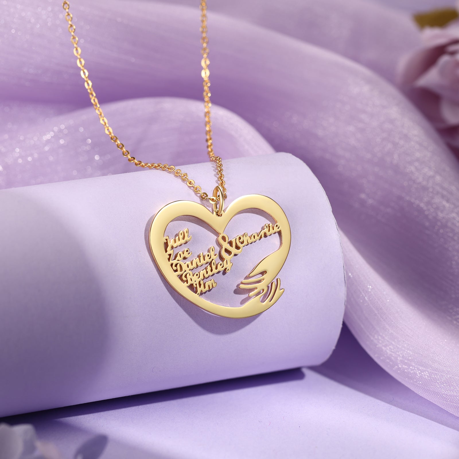 Gold-plated heart-shaped pendant necklace with two hands hugging and custom engraved names.