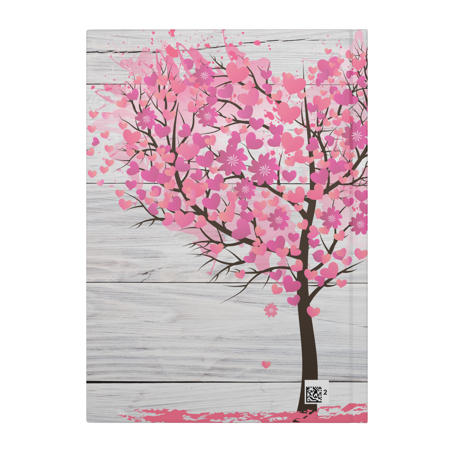 Journal cover with pink cherry blossom tree and heart-shaped petals on a whitewashed wooden background.
